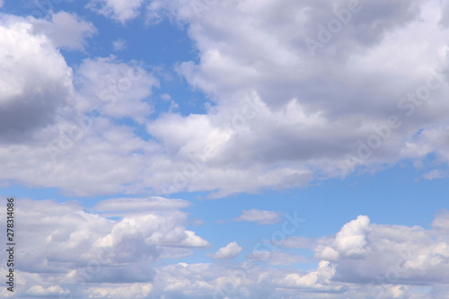 Fototapeta Naklejka Na Ścianę i Meble -  Blue sky texture background with white fluffy clouds. Horizontal, nobody, place for text. The concept of nature and meteorology.