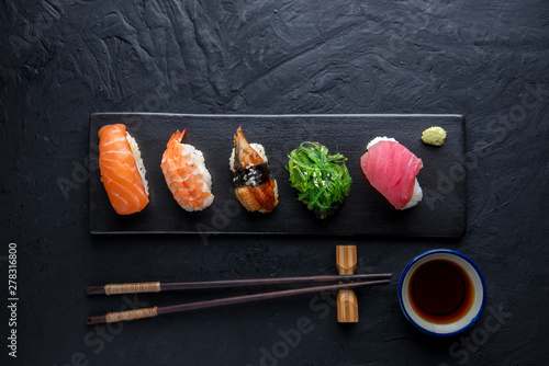 Set of sushi on dark stone table. Top