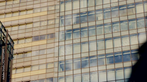 Windows of Modern Business Commercial Building in Tokyo Japan With Pedestrian Passing By photo