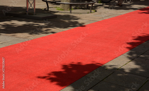 red carpet in the pedestrian zone for vip, rolled out red carpet by day no people for an evening event photo