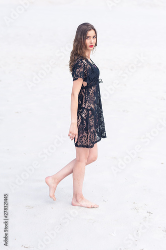 Beautiful young woman posing on the sand dune. Summer fashion swimwear.
