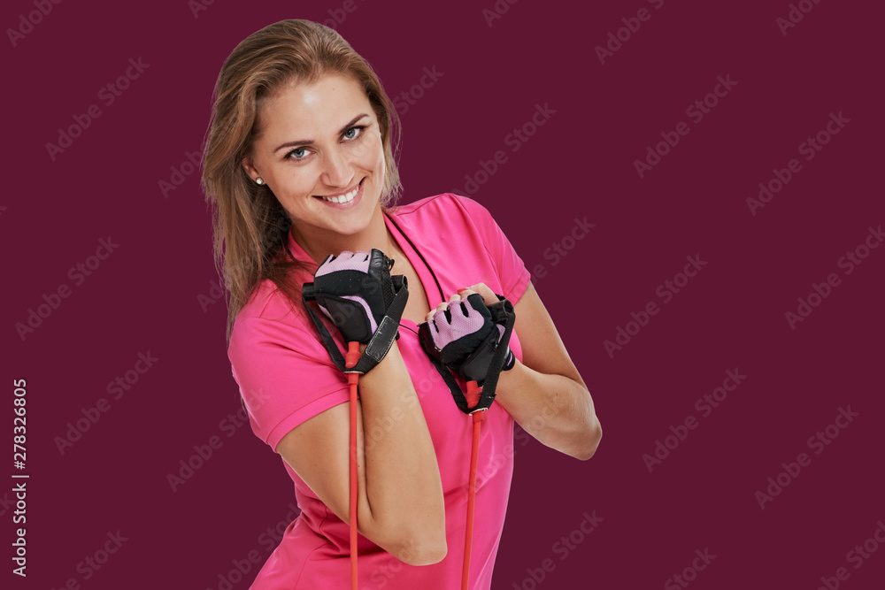 Obraz premium athletic woman with rubber tape on background mulberry shade violet. studio portrait