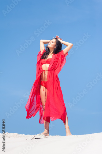 Summer Fashion. Sexy European Woman In Red Swimsuit On Beach