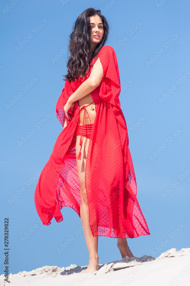 Summer Fashion. Sexy European Woman In Red Swimsuit On Beach Summer Fashion. Sexy European Woman In Red Swimsuit On Beach