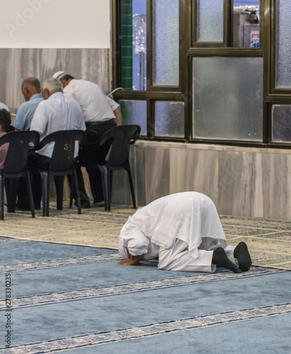 Muslim believers pray in prayer room of the Ahmadiyya Shaykh Mahmud mosque in Haifa city in Israel