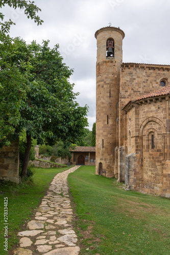 Vertical view with path of the Collegiate Church of San Martin de Elines of the twelfth century in Cantabria, Spain, Europe photo