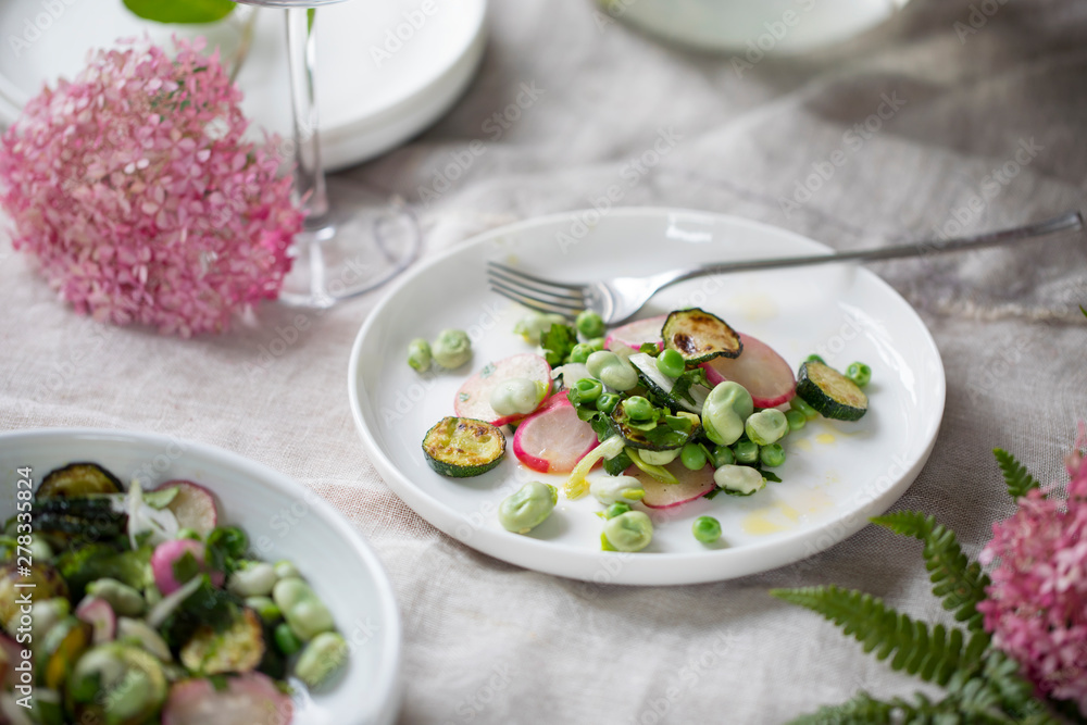 Fresh garden salad with broad beans, green peas, radishes and courgette Fresh garden salad with broad beans, green peas, radishes and courgette