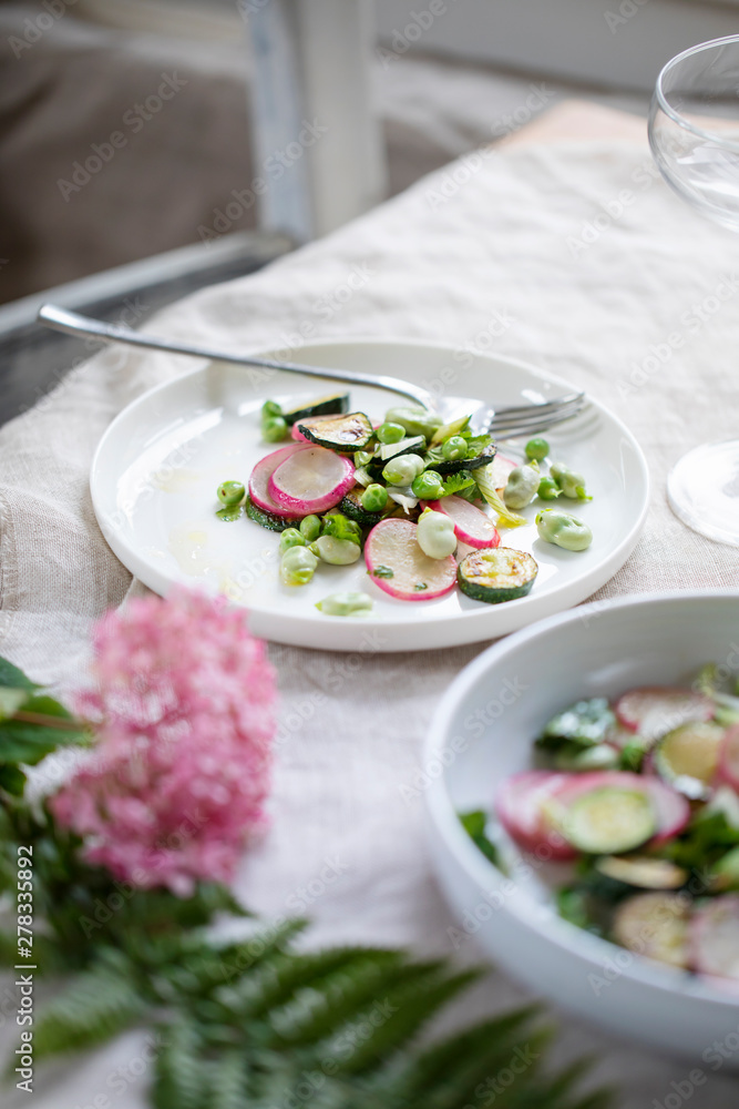 Fresh garden salad with broad beans, green peas, radishes and courgette Fresh garden salad with broad beans, green peas, radishes and courgette