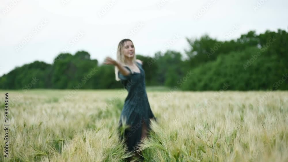 Portrait of a happy attractive Caucasian blonde with wet hair spinning in the rain on nature. Outdoor field of wheat. Happiness hope flirting and coquetry. Shallow depth of field Portrait of a happy attractive Caucasian blonde with wet hair spinning in the rain on nature. Outdoor field of wheat. Happiness hope flirting and coquetry. Shallow depth of field