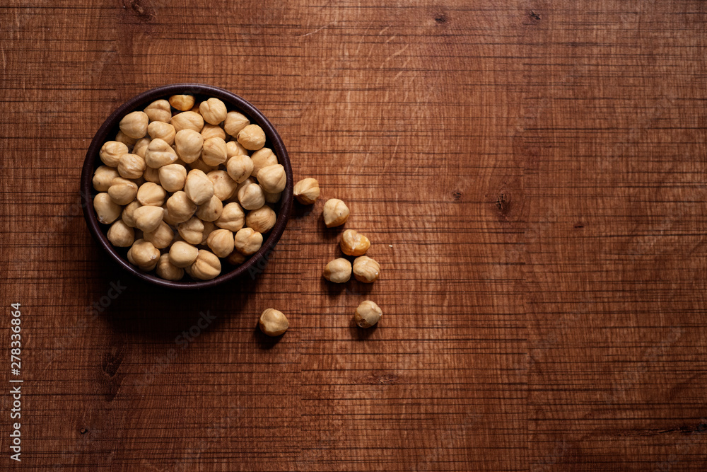 Shelled hazelnuts on a wooden chopping board Shelled hazelnuts on a wooden chopping board