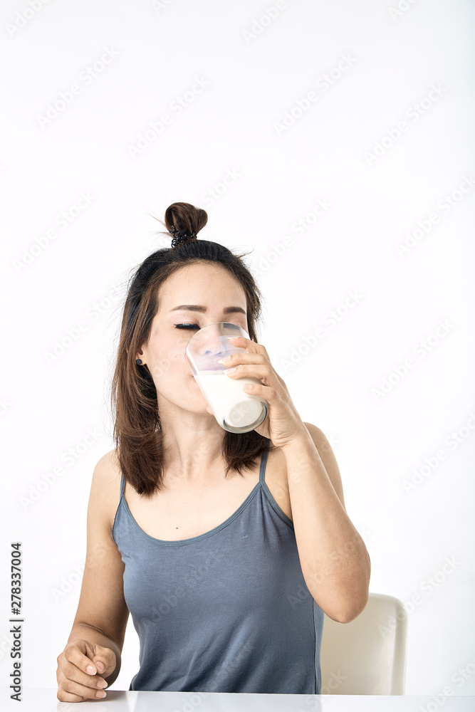 young woman drinking milk on table young woman drinking milk on table