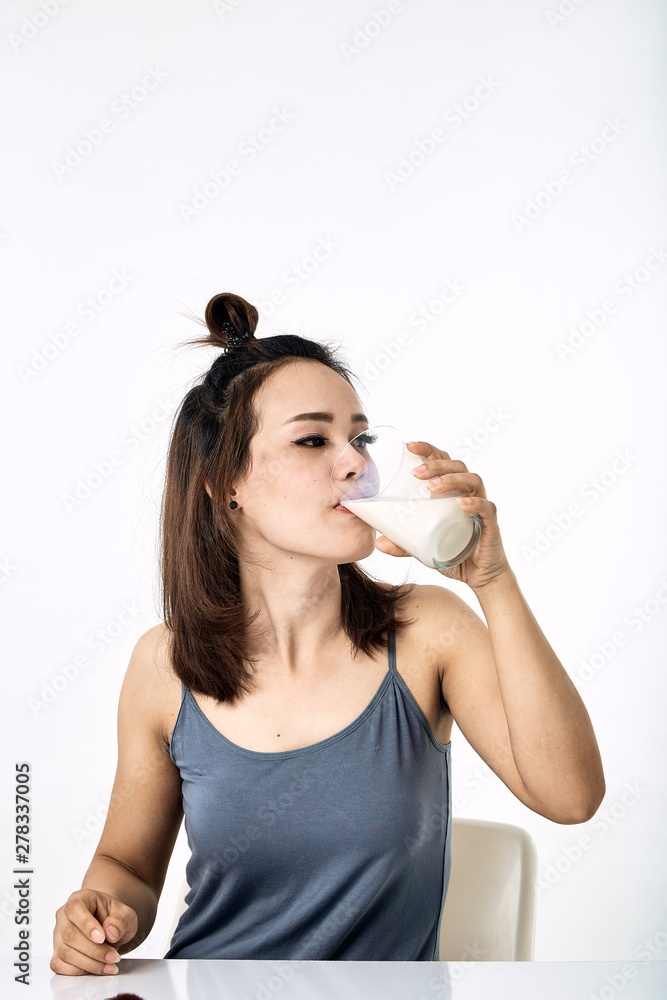 young woman drinking milk on table young woman drinking milk on table