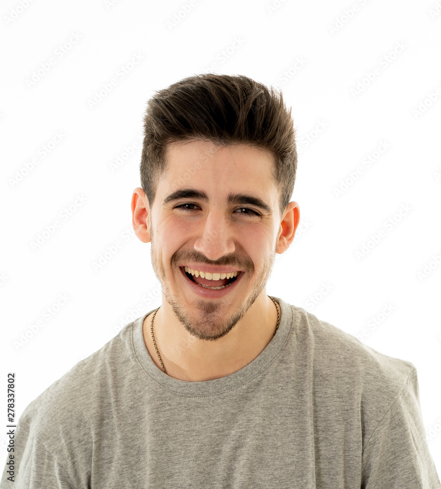 Portrait of smiling attractive cheerful young man face. In human facial emotions and expressions Portrait of smiling attractive cheerful young man face. In human facial emotions and expressions