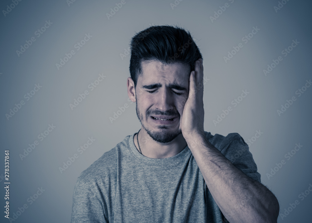 Human expressions, emotions. Young attractive man with sad face, looking depressed and unhappy Human expressions, emotions. Young attractive man with sad face, looking depressed and unhappy