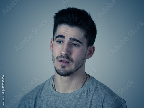 Human expressions, emotions. Young attractive man with sad face, looking depressed and unhappy