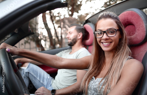 modern young woman sitting behind the wheel of a convertible car © ASDF