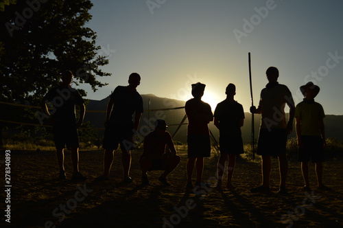 Team of Hikers in the Mountains Standing Ready at Sunrise as Silhouettes © DearTravallure
