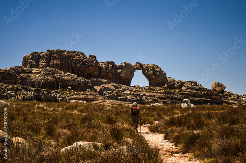 Hiker Walking Towards Wolfberg Arch in Cederberg Wilderness, Cape Town, South Africa