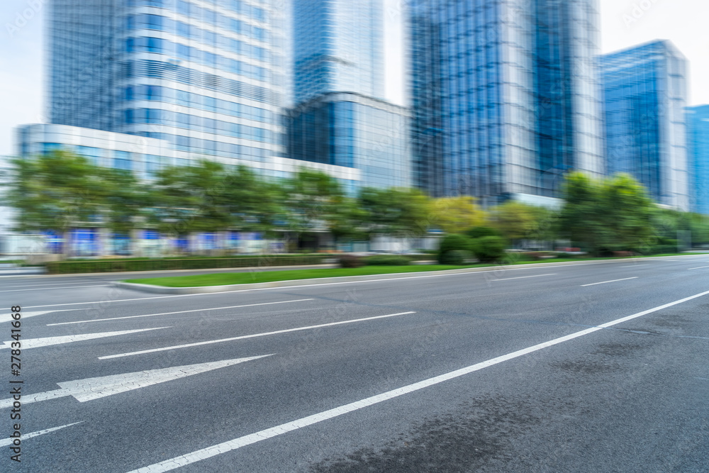 blurred empty urban road and modern buildings blurred empty urban road and modern buildings