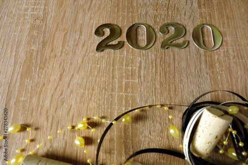 Number 2020 with ornaments on wooden background