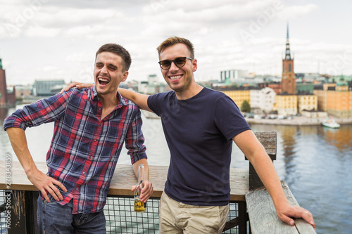 Photography Portrait of the smiling young friends who are standing against the background of