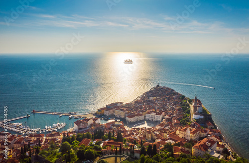 Aerial view of the old city Piran and beautiful sailing ship with five masts at sunset time. Slovenia, Europe photo