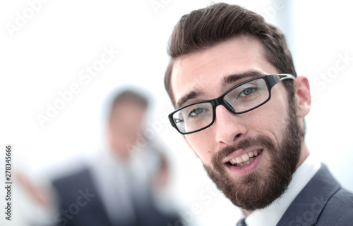 close up.smiling businessman in the office background