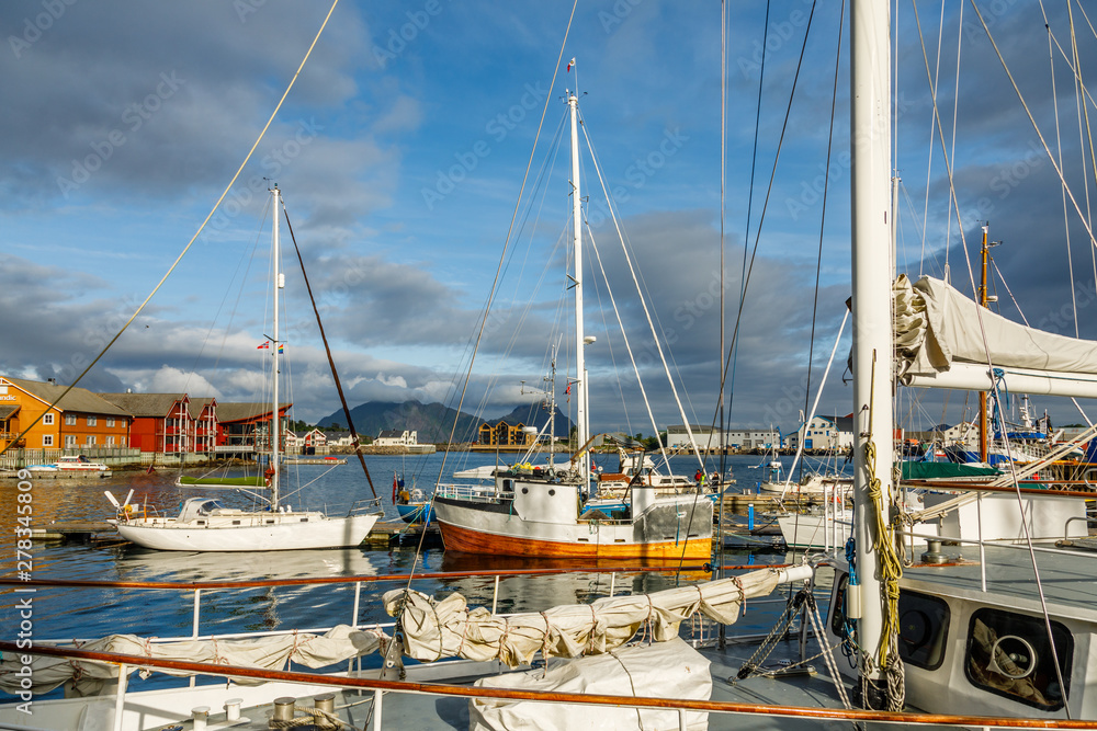 Yachts and boats with mountain in the background at pier in Svolvaer, Lototen islands, Austvagoya, Vagan Municipality, Nordland County, Norway Yachts and boats with mountain in the background at pier in Svolvaer, Lototen islands, Austvagoya, Vagan Municipality, Nordland County, Norway