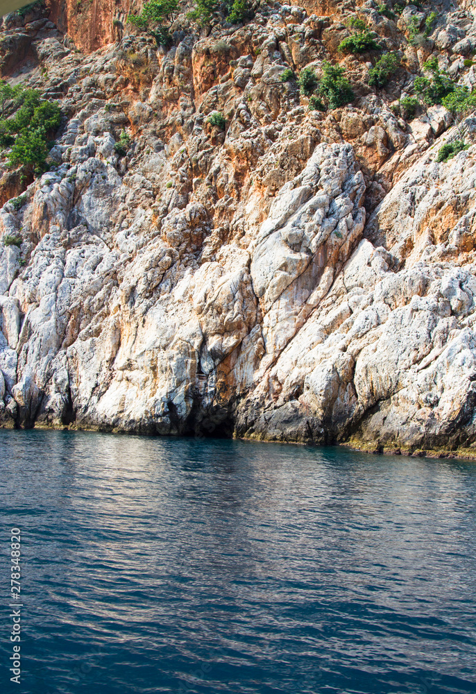 White cliffs and bright blue Mediterranean sea. Rest on the Mediterranean sea in Turkey. Summer, Sunny day