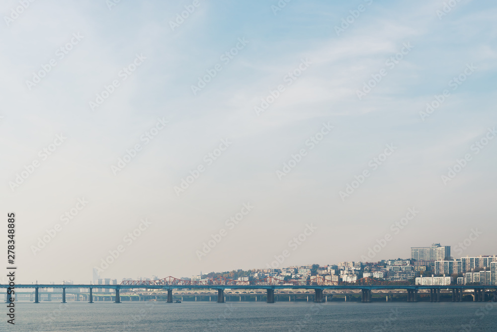 View of the Han river and the bridge in morning time. Picture with grain and color from film simulation filter.