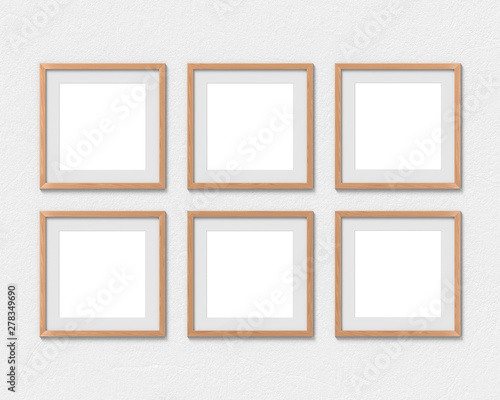 Set of 6 square wooden frames mockup with a border hanging on the wall. Empty base for picture or text. 3D rendering. © photolas