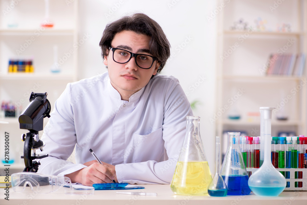 Young male biochemist working in the lab Young male biochemist working in the lab