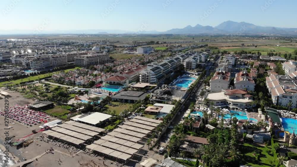 A panoramic view of a number of resorts an villas in Belek, Turkey with mountains in the distance on a sunny summer day A panoramic view of a number of resorts an villas in Belek, Turkey with mountains in the distance on a sunny summer day