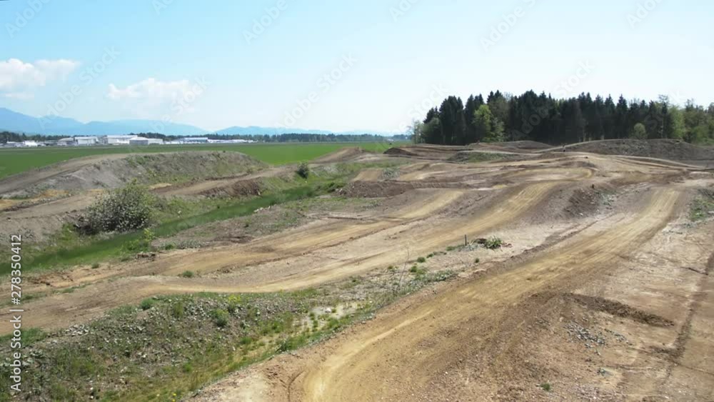 Video lapse of motocross track with bikers driving on it Video lapse of motocross track with bikers driving on it