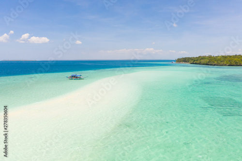 Mansalangan sandbar, Balabac, Palawan, Philippines. Tropical islands with turquoise lagoons, view from above. Boat and tourists in shallow water.