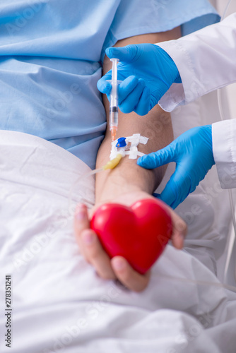 Male patient getting blood transfusion in hospital clinic