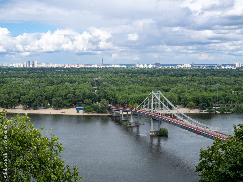 Aerial view of the Pedestrian bridge over the Dnieper river in the centre of Kiev, Ukraine, cloudy sky Aerial view of the Pedestrian bridge over the Dnieper river in the centre of Kiev, Ukraine, cloudy sky