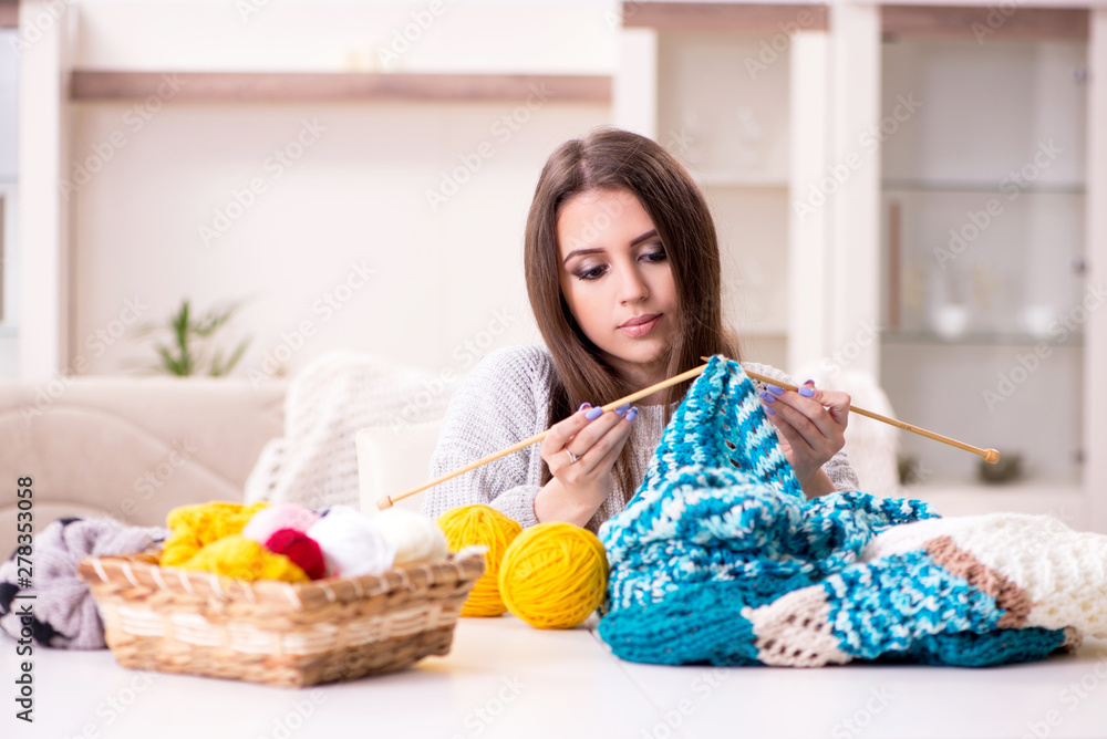 Young beautiful woman knitting at home Young beautiful woman knitting at home