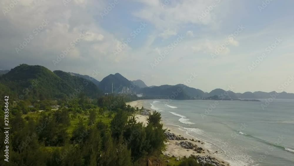 Beautiful tropical beach aerial - a bird's eye view of ocean waves and land Beautiful tropical beach aerial - a bird's eye view of ocean waves and land