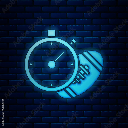 Glowing neon American Football ball and stopwatch icon isolated on brick wall background. Set of sport equipment. Vector Illustration