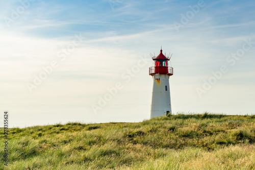 Lighthouse red white on dune.