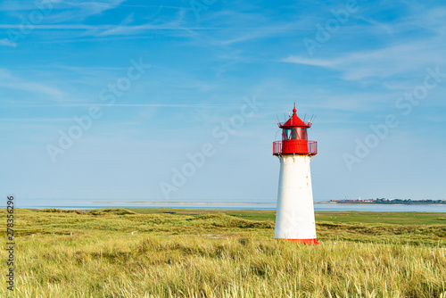 Lighthouse red white on dune.