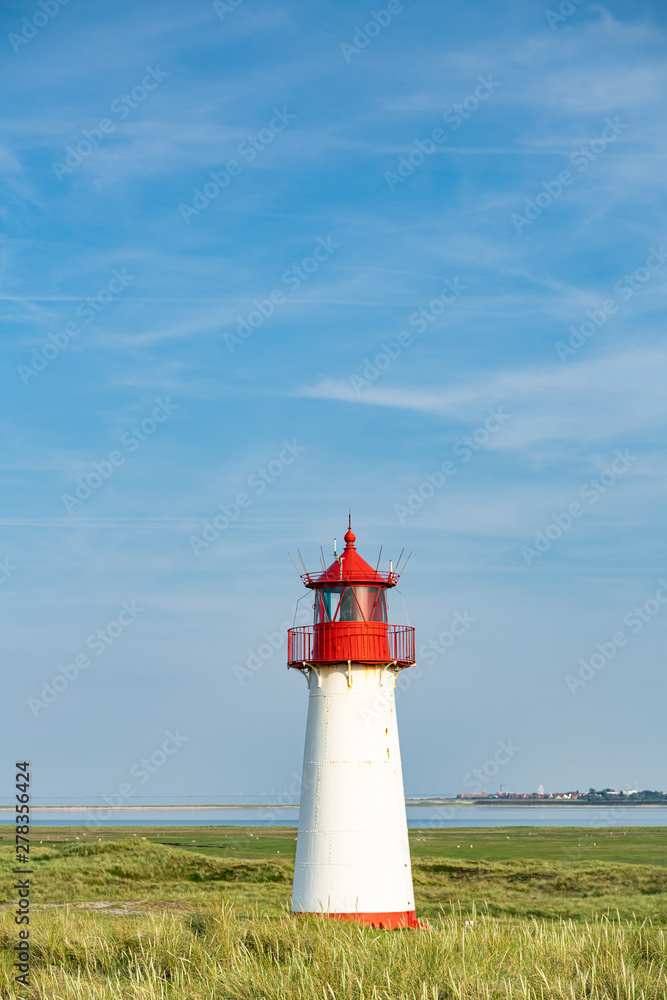 Lighthouse red white on dune.