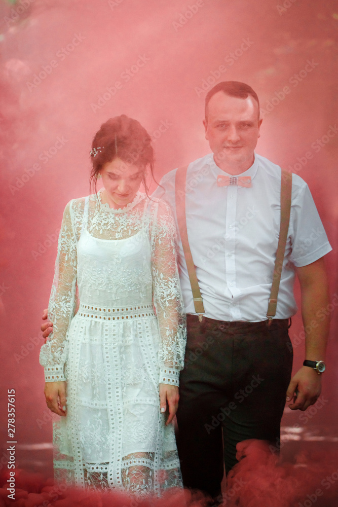 bride and groom in red smoke