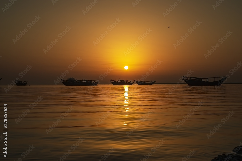 Beautiful Sunrise Boat in seaside with yellow and dark sky. Dammam -Saudi Arabia Beautiful Sunrise Boat in seaside with yellow and dark sky. Dammam -Saudi Arabia