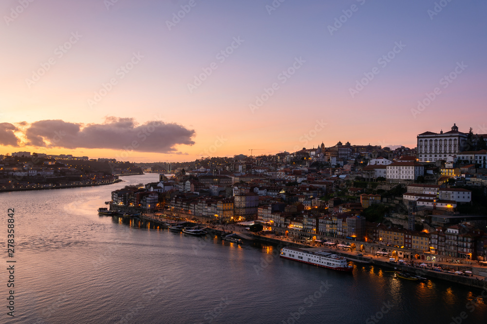 View to the city of Porto from D. Luis I bridge at sunset