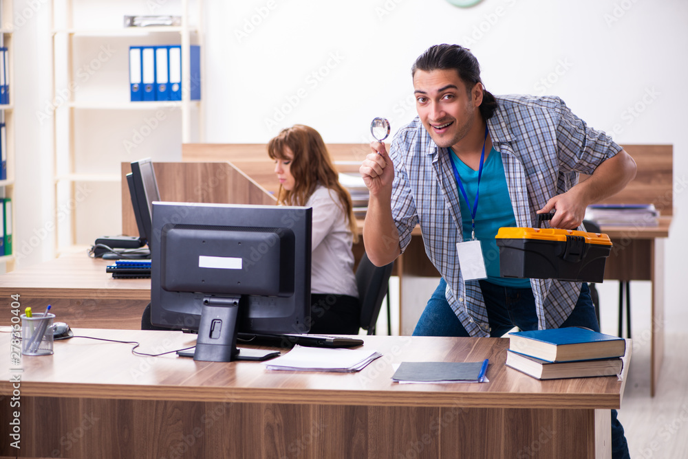 Young male it specialist in the office Young male it specialist in the office