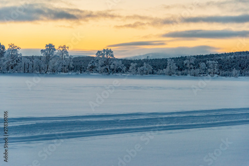 Frozen lake under a red sky in Lapland © CharnwoodPhoto