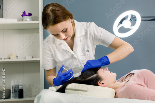 Fototapeta Naklejka Na Ścianę i Meble -  Mesotherapy For Hair Growth. Woman Receiving Injection In Head in cosmetology clinic