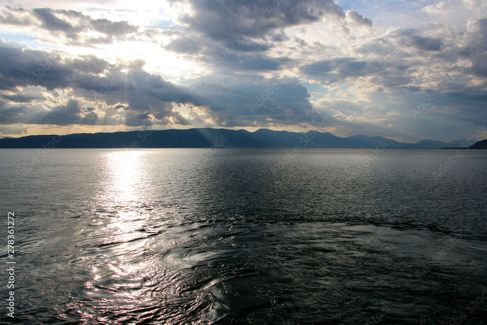 Storm clouds with clearance of sun over on the beautiful Lake Ohrid, Republic of North Macedonia